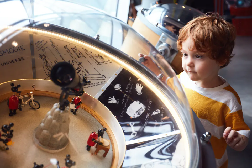 Interactive science exhibit at Palace of Wonders with children experimenting