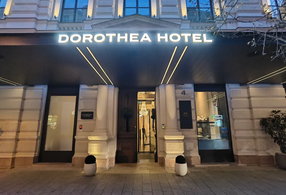 Illuminated entrance of Dorothea Hotel at night with classic architecture and modern signage