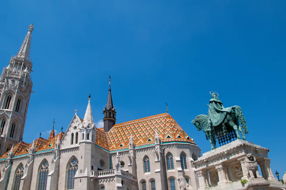 Matthias Church with colorful tiled roof and Gothic spires against blue sky