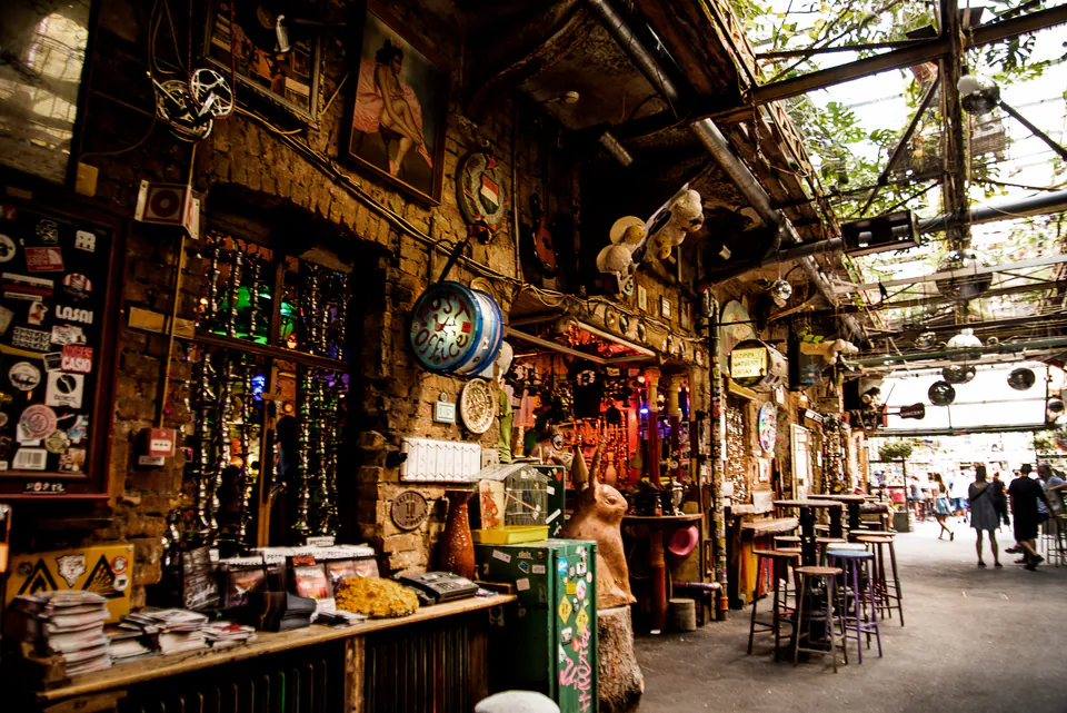Interior of an eclectic Budapest ruin bar with vintage decorations and artistic lighting