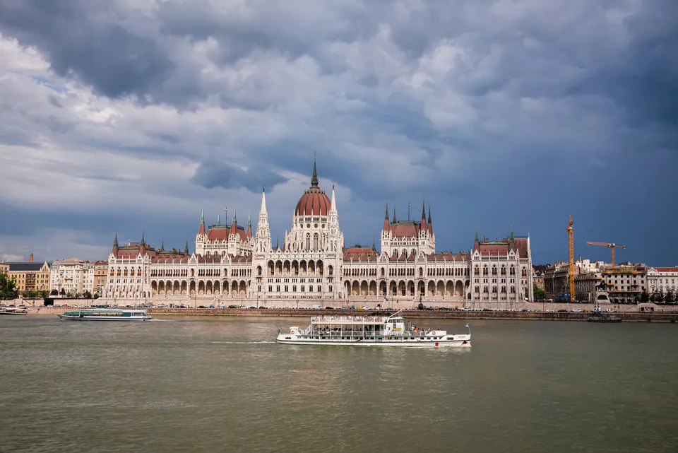 River cruise boat passing Hungarian Parliament Building along the Danube River