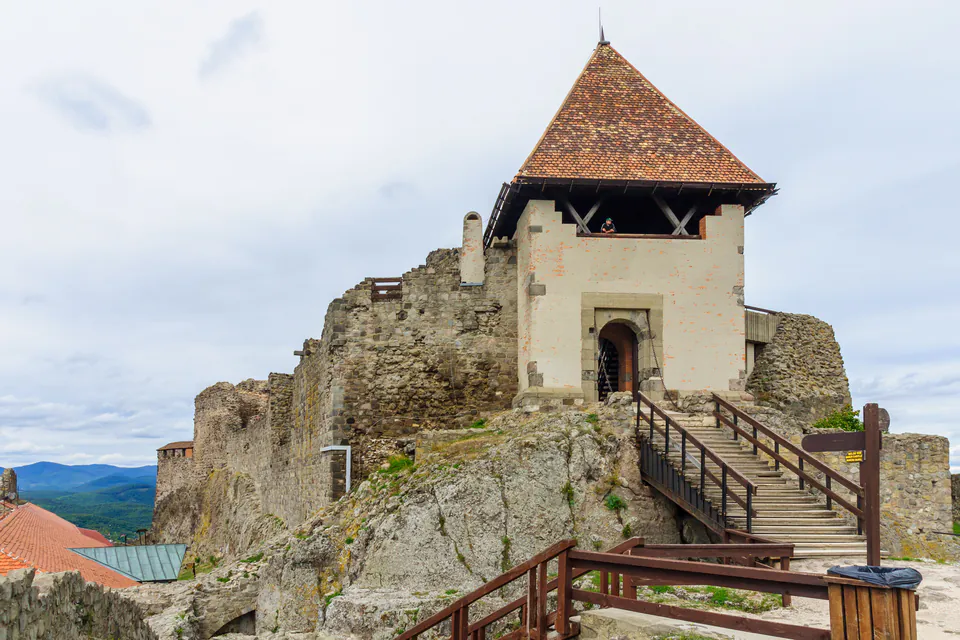 Medieval tower entrance with stone stairway leading to doorway at Visegrád Citadel