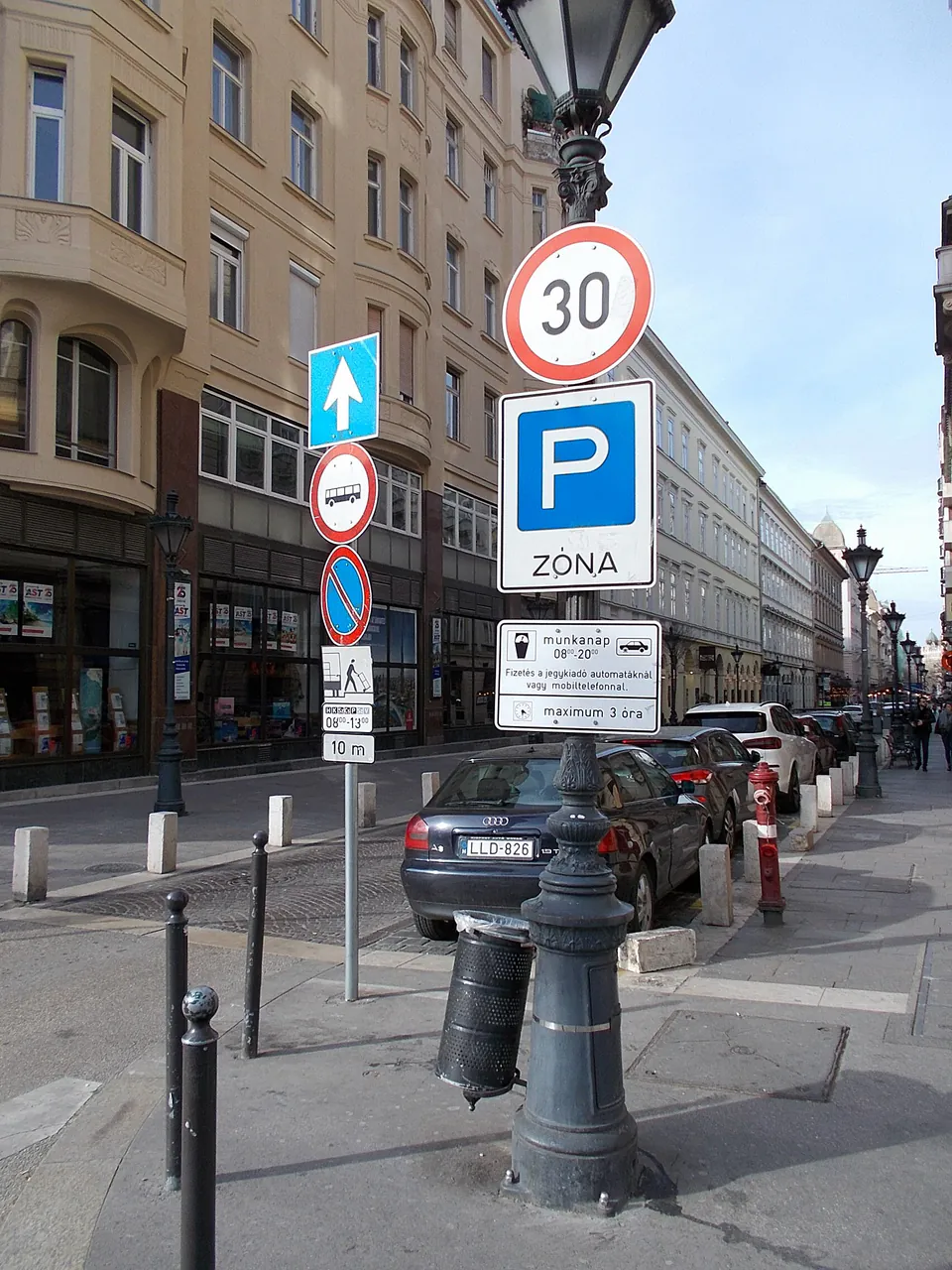 Street signs showing parking zone regulations, speed limit, and other traffic rules in Budapest