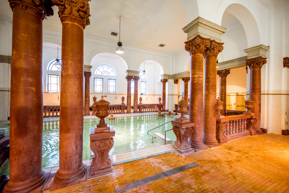 Elegant thermal bath interior with seniors relaxing in mineral-rich waters