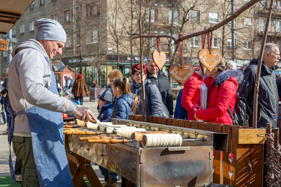Local food guide demonstrates traditional Hungarian cooking techniques to tour participants