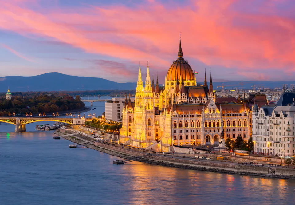 Budapest Parliament building reflecting in Danube River at sunset
