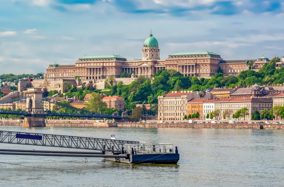 Buda Castle and Royal Palace complex viewed from Danube River with boat dock in foreground