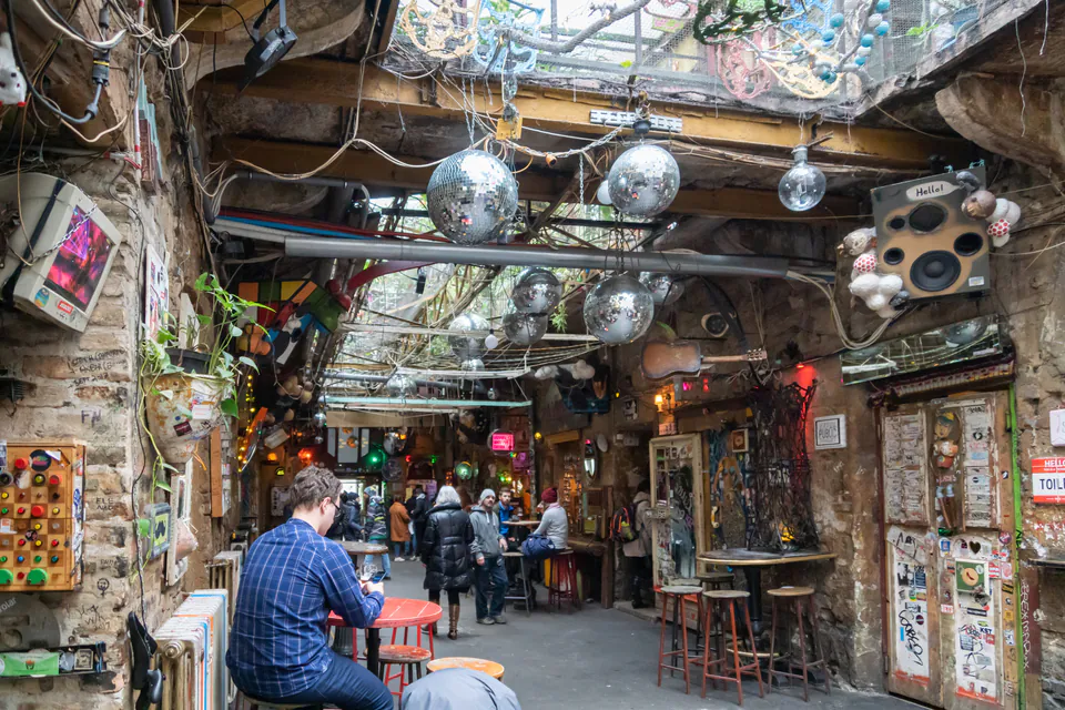Interior courtyard of Szimpla Kert with disco balls, exposed brick walls and eclectic decorations