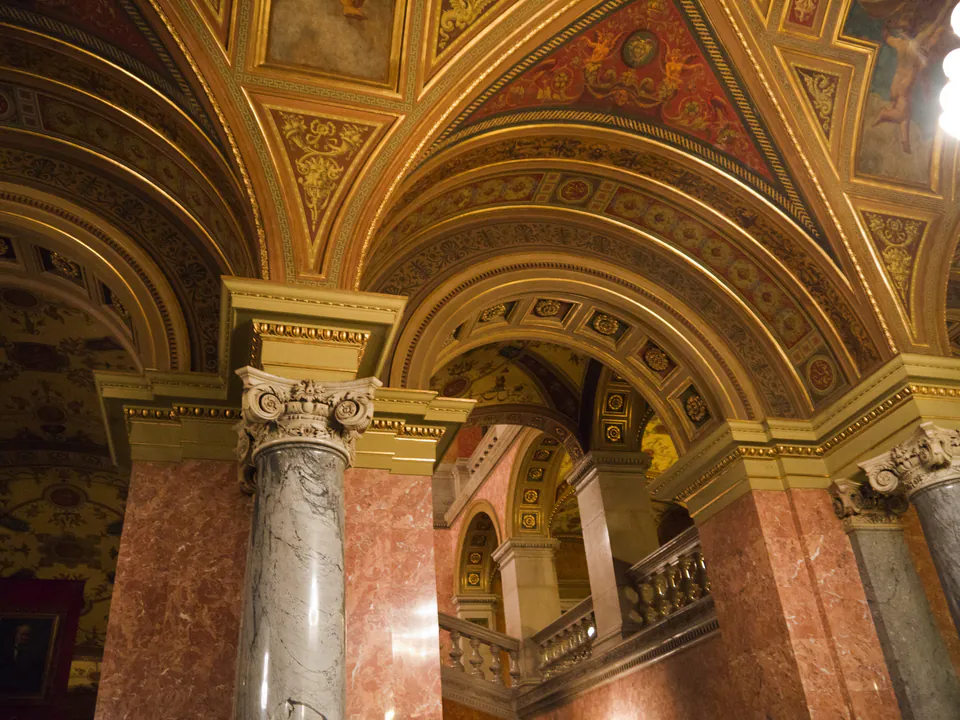 Ornate vaulted ceilings and marble columns in the grand staircase area of the Opera House