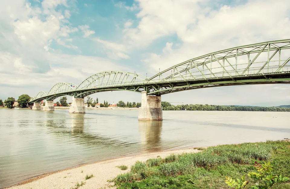 Maria Valeria Bridge spans the Danube River connecting Hungary and Slovakia under blue skies
