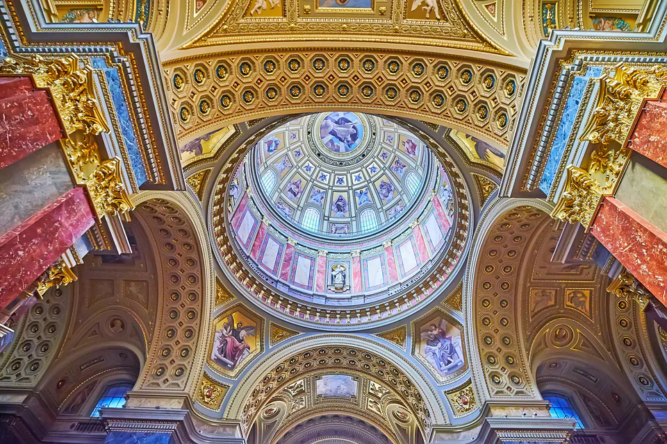 Ornate baroque hall with marble columns, gilded details, and domed ceiling in St. Stephen's Hall