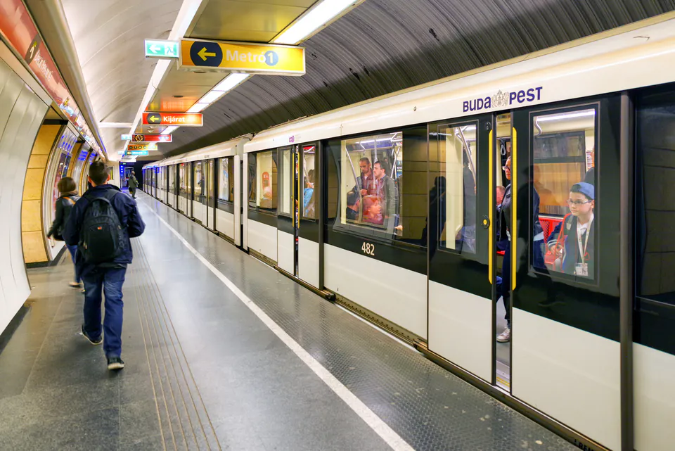 Budapest metro station platform with modern trains and clear signage