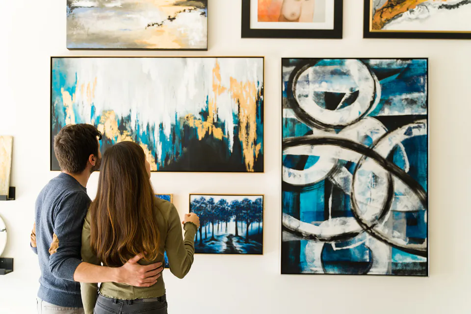 Visitors viewing contemporary artwork displayed on gallery walls at an art exhibition