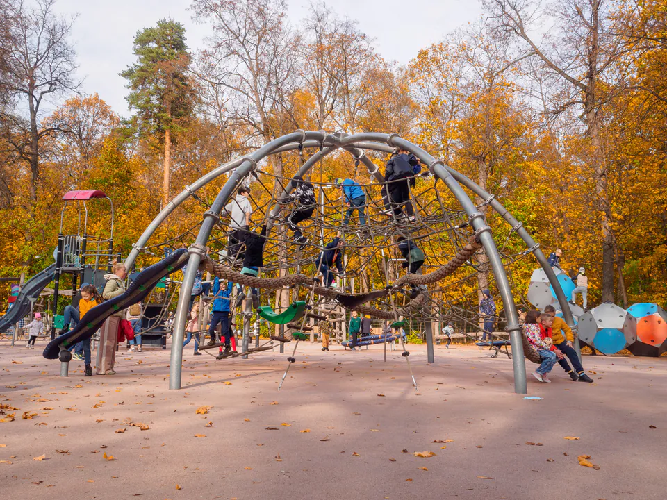 Large modern playground in City Park with climbing structures and slides