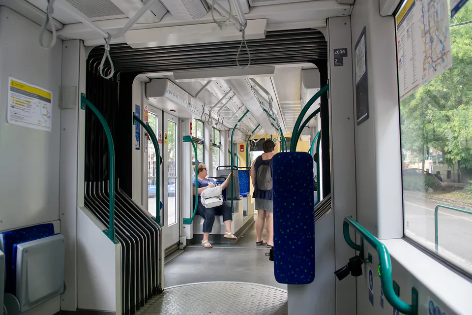 Interior of modern Budapest bus showing wheelchair space and accessibility features