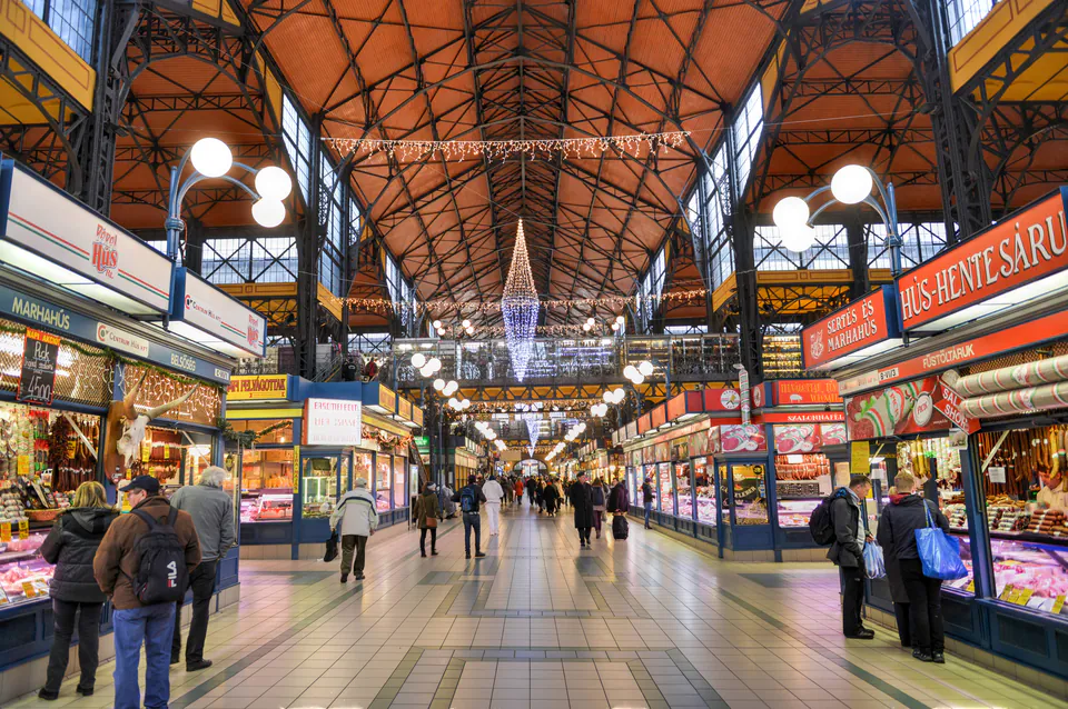 Great Market Hall interior showing colorful produce stalls and Zsolnay tile roof