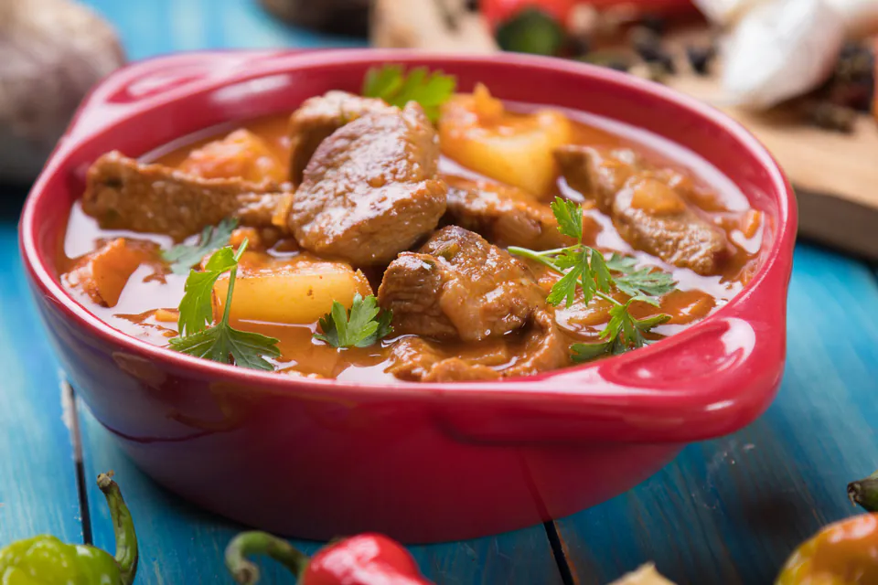 Traditional Hungarian goulash served in ceramic bowl with fresh bread