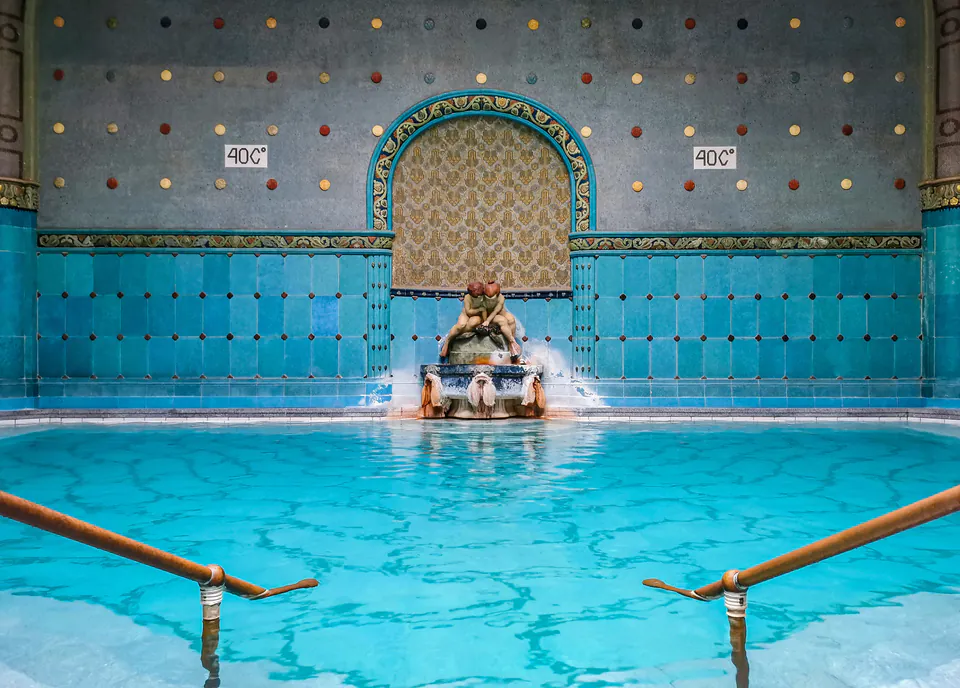 Thermal pool with ornate blue tiled walls and steaming mineral water at 40°C