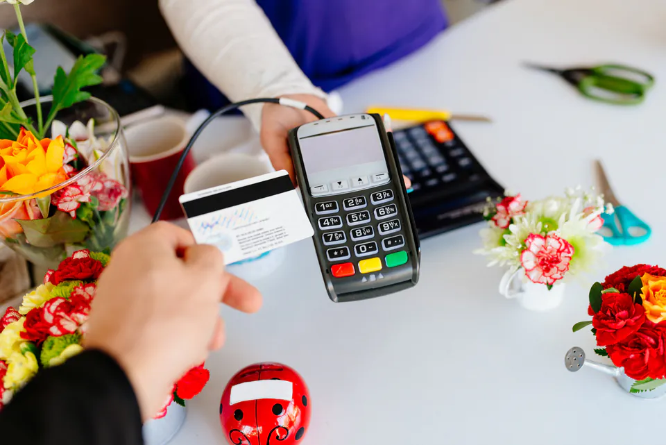 Credit card payment being processed at car rental counter