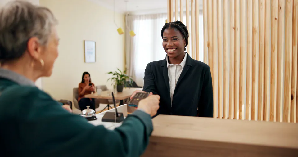 Hungarian greeting exchange between travelers and hotel staff in Budapest lobby