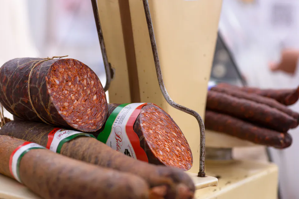Close-up of sliced Hungarian salami with traditional casing and spices visible in cross-section