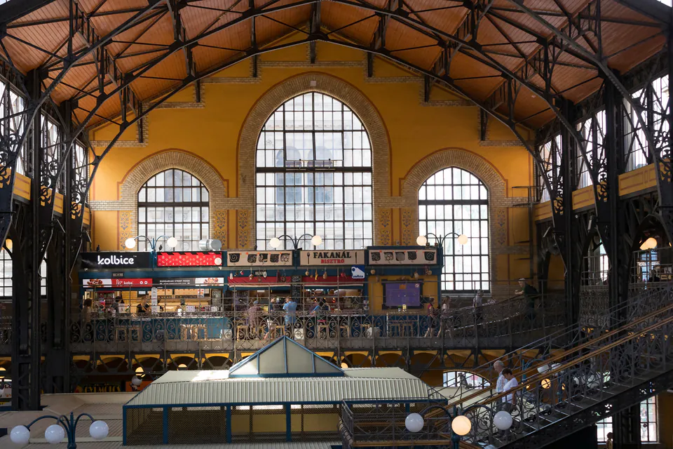 Interior of Budapest's Great Market Hall showing arched windows and vendor stalls