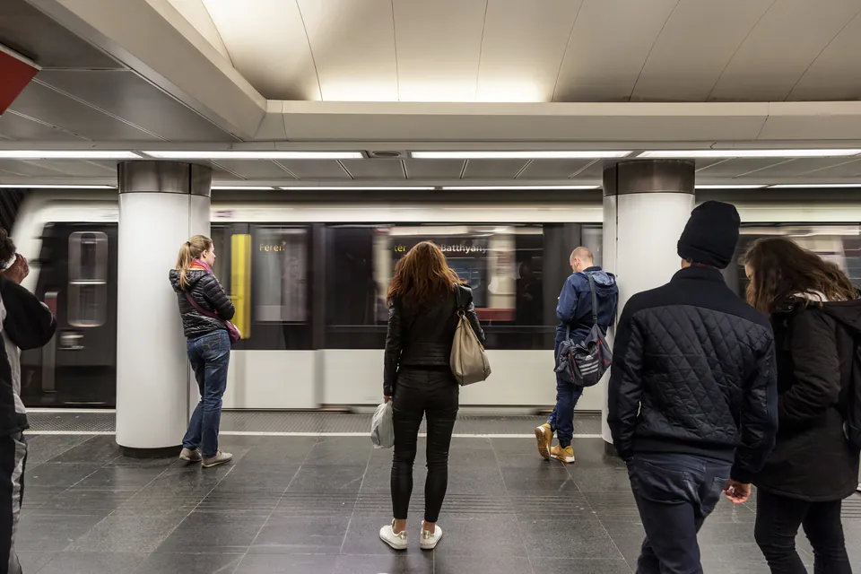 Busy metro platform during rush hour with passengers waiting for train