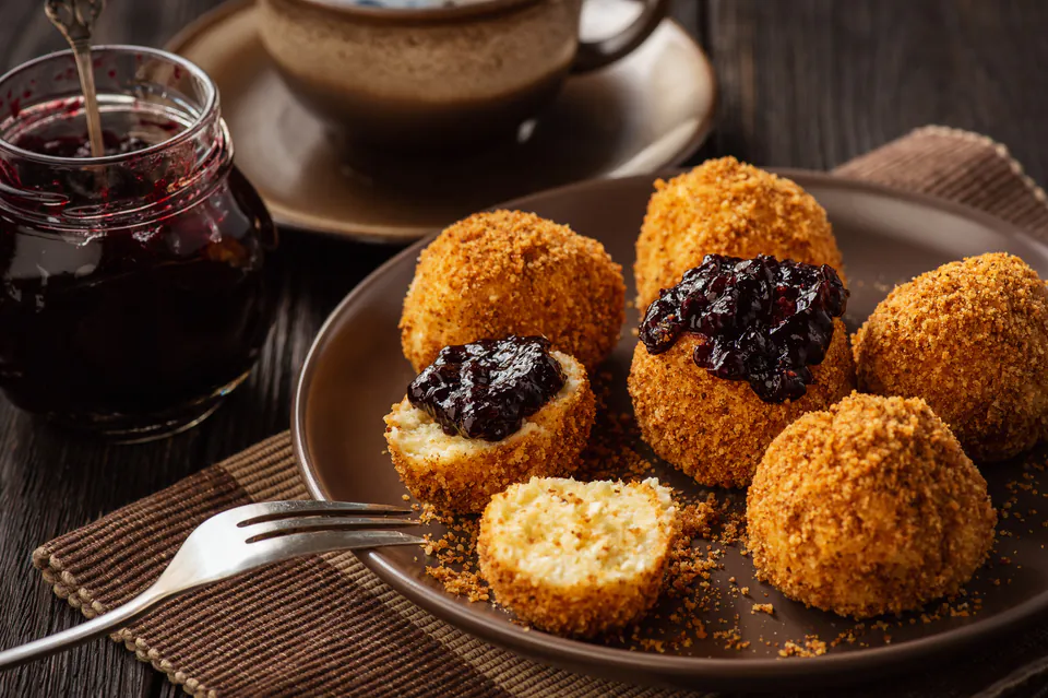 Golden túrógombóc cheese dumplings with toasted breadcrumbs and dark berry jam