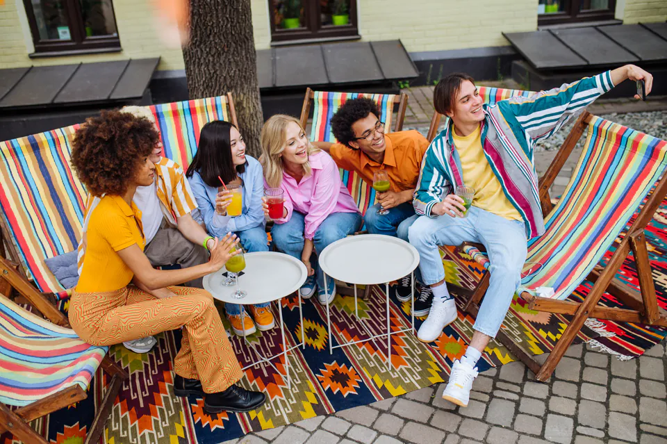 Colorful outdoor lounge area with striped deck chairs and small tables