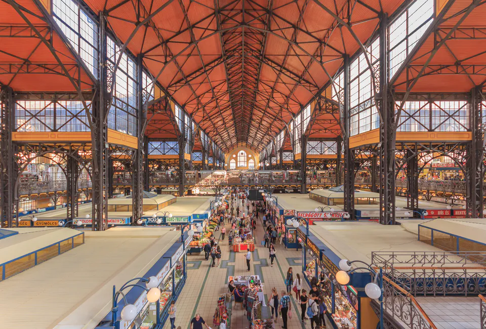 Interior view of Budapest's Great Market Hall showing long corridor with vendors and ornate architecture