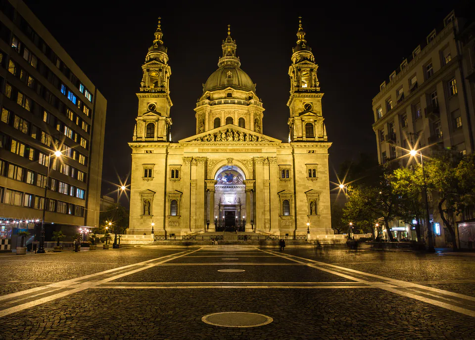 St. Stephen's Basilica illuminated at night with golden lights highlighting its architectural features