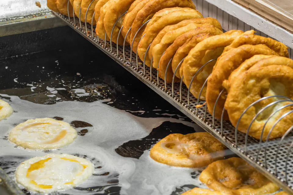 Traditional Hungarian lángos with toppings displayed at a local market stall