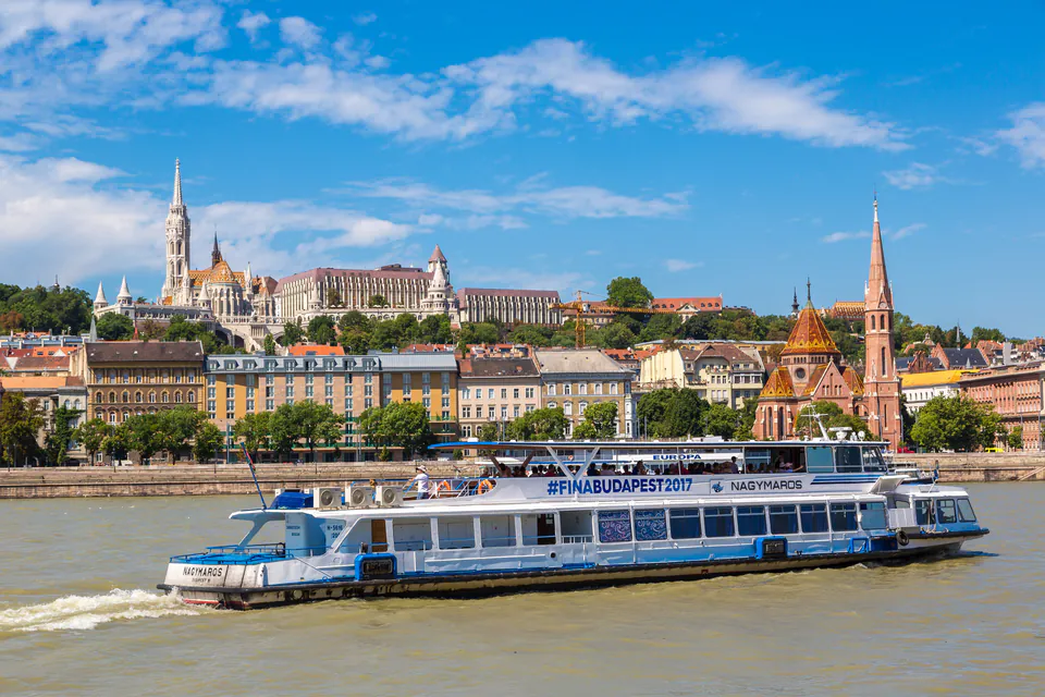 Tourist sightseeing boat on Danube with Parliament building in background