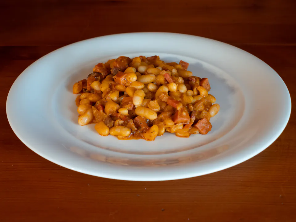Bean goulash served on white ceramic plate, showcasing traditional Hungarian preparation