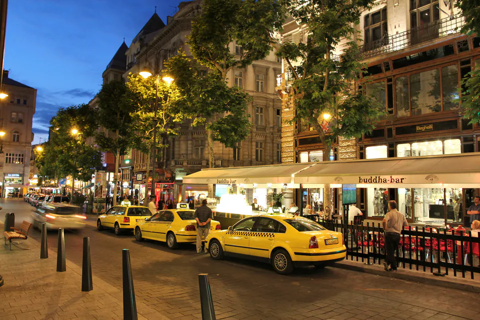 Yellow Budapest taxi at night with official taxi sign illuminated