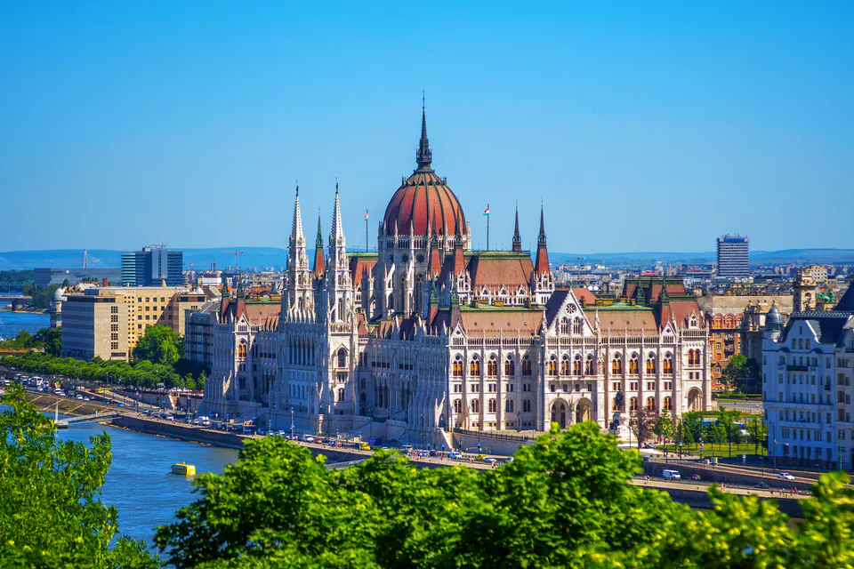 Hungarian Parliament Building along the Danube River on a bright summer day with clear blue skies