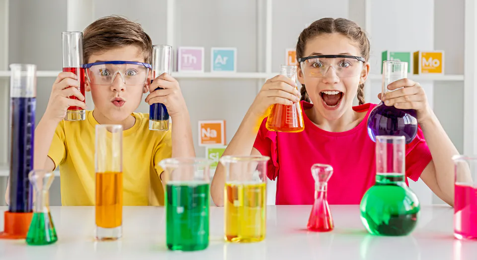 Young children in lab coats conducting safe science experiments